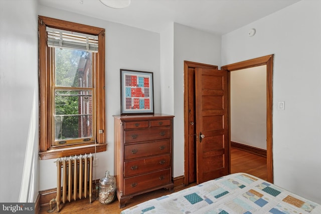 527 S 55th St, Philadelphia, PA 19143 - bedroom with radiator heating unit, wood finished floors, and baseboards