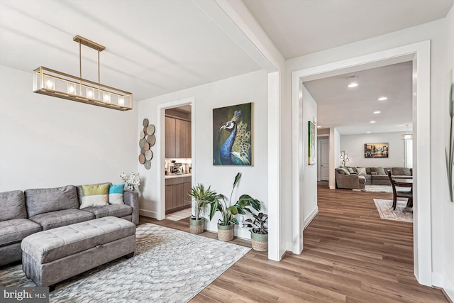 42023 Spring Air Dr, Brambleton, VA 20148 - living room with wood finished floors, baseboards, a chandelier, and recessed lighting