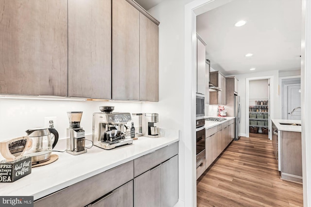 42023 Spring Air Dr, Brambleton, VA 20148 - kitchen featuring a sink, light wood-style floors, stainless steel appliances, light countertops, and recessed lighting