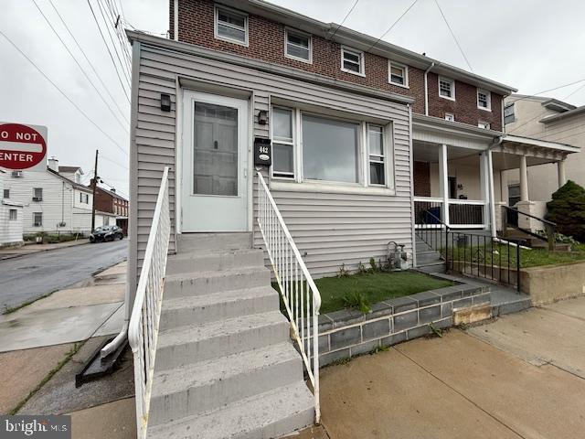 442 E Baltimore Ave, Clifton Heights, PA 19018 - view of front of property featuring covered porch, brick siding, and entry steps