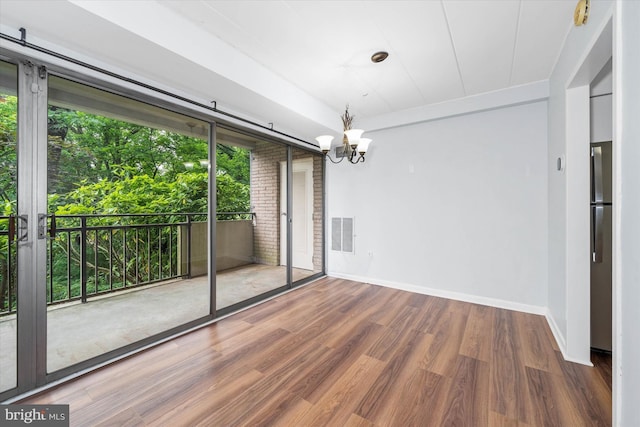 2300 Riddle Ave Unit A4, Wilmington, DE 19806 - unfurnished dining area featuring baseboards, a chandelier, and wood finished floors