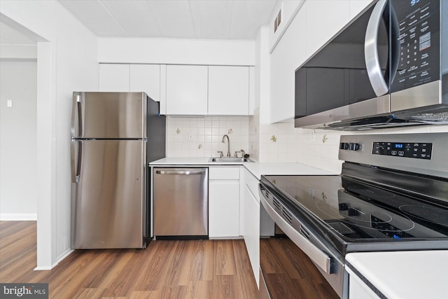 2300 Riddle Ave Unit A4, Wilmington, DE 19806 - kitchen with appliances with stainless steel finishes, a sink, light wood-style flooring, and white cabinetry