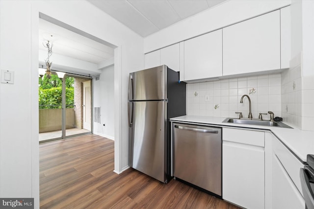 2300 Riddle Ave Unit A4, Wilmington, DE 19806 - kitchen with appliances with stainless steel finishes, a sink, dark wood-style floors, light countertops, and white cabinetry