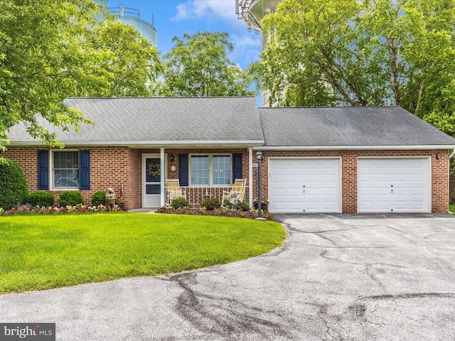 2807 Carlisle Dr Unit 29, New Windsor, MD 21776 - view of front of home with a garage, brick siding, asphalt driveway, a front yard, and a shingled roof