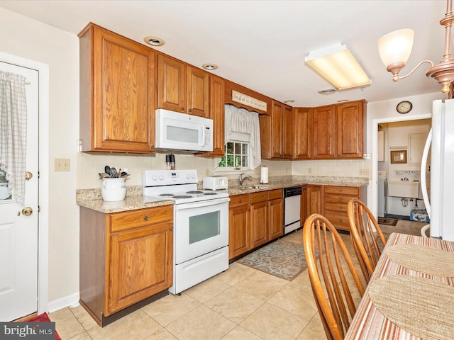 2807 Carlisle Dr Unit 29, New Windsor, MD 21776 - kitchen with white appliances, a sink, decorative backsplash, and brown cabinetry