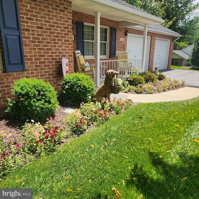 2807 Carlisle Dr Unit 29, New Windsor, MD 21776 - view of exterior entry with brick siding, covered porch, driveway, and an attached garage