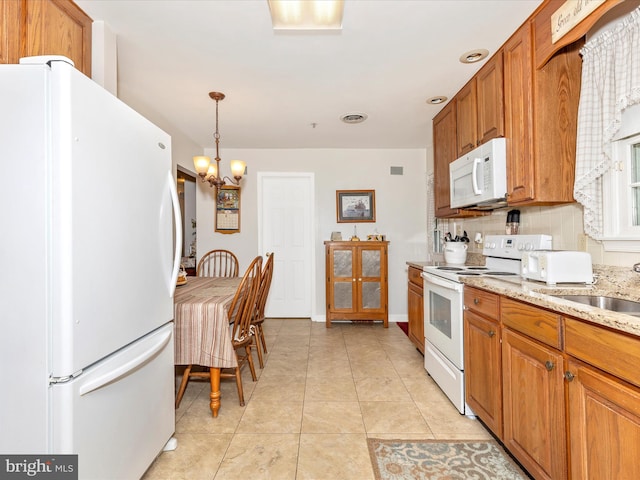 2807 Carlisle Dr Unit 29, New Windsor, MD 21776 - kitchen with white appliances, backsplash, brown cabinetry, a chandelier, and a sink