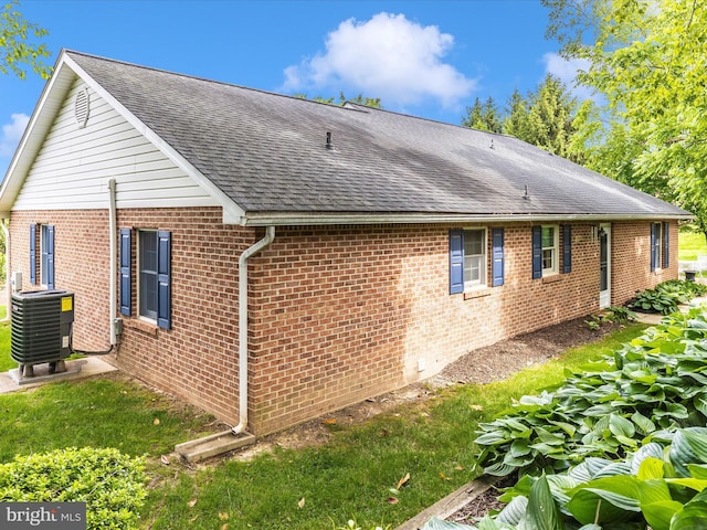 2807 Carlisle Dr Unit 29, New Windsor, MD 21776 - view of property exterior with cooling unit, a shingled roof, and brick siding