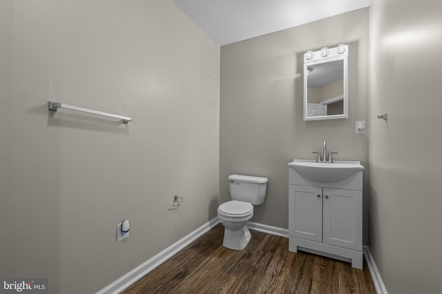 273 Thomas Harmon Dr, Camden Wyoming, DE 19934 - half bathroom with vanity, wood finished floors, toilet, and baseboards