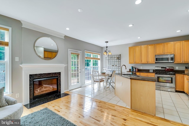 9 Cherry Ct, Lafayette Hill, PA 19444 - kitchen with stainless steel appliances, a sink, a premium fireplace, a chandelier, and recessed lighting