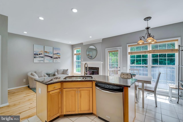 9 Cherry Ct, Lafayette Hill, PA 19444 - kitchen featuring stainless steel dishwasher, a sink, open floor plan, dark stone countertops, and a glass covered fireplace
