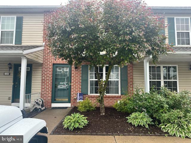 106 Pebble Ln, Bellefonte, PA 16823 - view of exterior entry with brick siding and covered porch