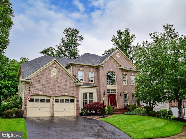 20369 Stillhouse Branch Pl, Sterling, VA 20165 - view of front facade featuring asphalt driveway, brick siding, a front lawn, and an attached garage
