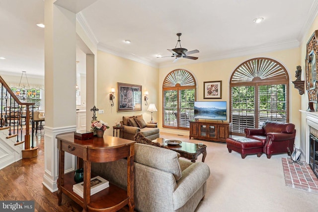 20369 Stillhouse Branch Pl, Sterling, VA 20165 - living room featuring stairs, ornamental molding, a glass covered fireplace, a ceiling fan, and plenty of natural light