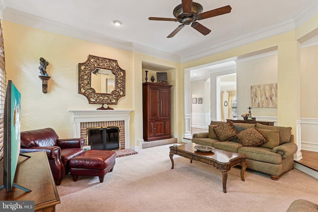 20369 Stillhouse Branch Pl, Sterling, VA 20165 - living area featuring light carpet, ceiling fan, ornamental molding, a brick fireplace, and wainscoting