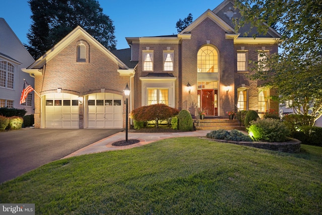 20369 Stillhouse Branch Pl, Sterling, VA 20165 - colonial-style house featuring driveway, brick siding, a front yard, and an attached garage