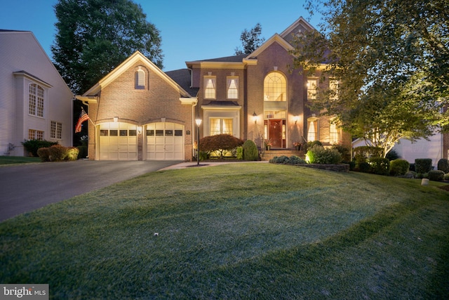 20369 Stillhouse Branch Pl, Sterling, VA 20165 - view of front of property featuring brick siding, asphalt driveway, a front lawn, and a garage