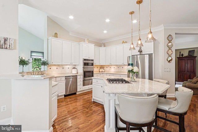 20369 Stillhouse Branch Pl, Sterling, VA 20165 - kitchen featuring appliances with stainless steel finishes, a warming drawer, a kitchen bar, tasteful backsplash, and white cabinets