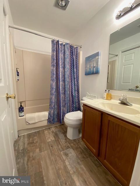 3605 Haley Ct, Wilmington, DE 19808 - full bathroom with vanity, toilet, wood finished floors, and shower / bath combination with curtain