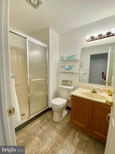 3605 Haley Ct, Wilmington, DE 19808 - bathroom featuring wood finished floors, vanity, a stall shower, and toilet