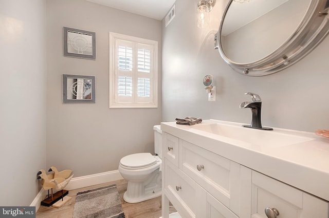 714 Alliance St, Havre De Grace, MD 21078 - bathroom with toilet, vanity, baseboards, and wood finished floors