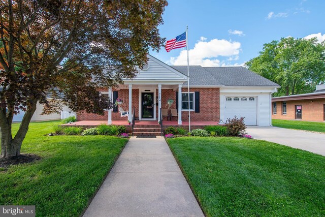714 Alliance St, Havre De Grace, MD 21078 - view of front of property with a porch, driveway, a garage, and a front lawn
