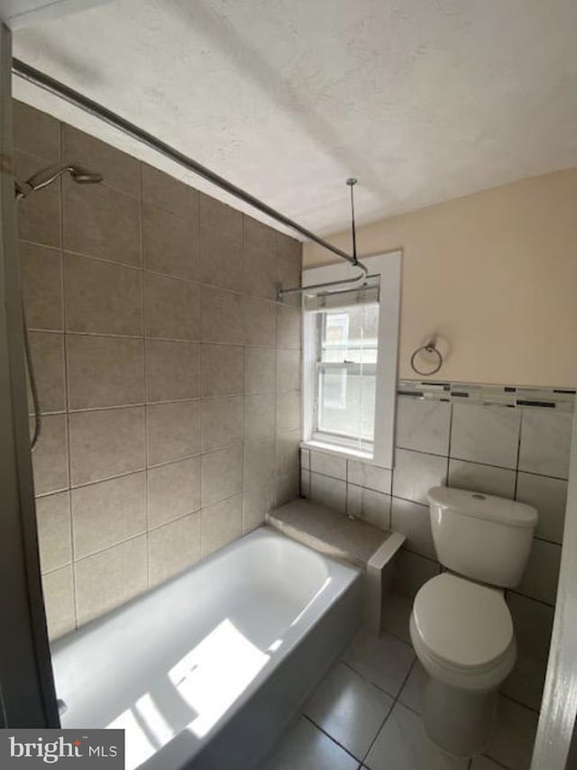 4216 Wyalusing Ave, Philadelphia, PA 19104 - bathroom featuring tile walls, toilet, shower / washtub combination, and tile patterned flooring