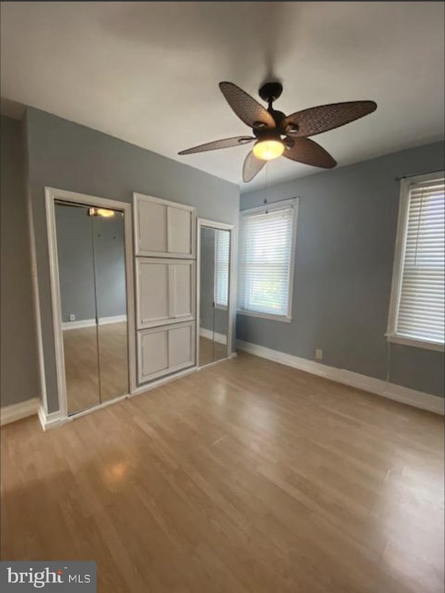 4216 Wyalusing Ave, Philadelphia, PA 19104 - unfurnished bedroom featuring multiple closets, baseboards, light wood-style flooring, and a ceiling fan