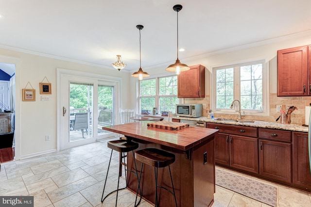 208 E Bradford Ct, Middletown, DE 19709 - kitchen with a sink, wood counters, crown molding, stainless steel appliances, and a kitchen island