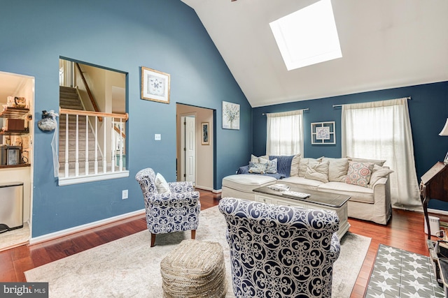 208 E Bradford Ct, Middletown, DE 19709 - living room featuring a skylight, stairway, wood finished floors, high vaulted ceiling, and baseboards