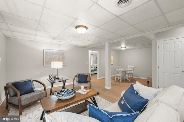 808 Pasadena Ave, Severna Park, MD 21146 - living area featuring a drop ceiling, light wood-style floors, and baseboards