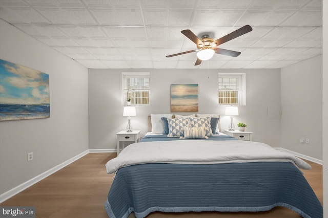 808 Pasadena Ave, Severna Park, MD 21146 - bedroom featuring multiple windows, baseboards, wood finished floors, and a ceiling fan