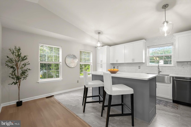 808 Pasadena Ave, Severna Park, MD 21146 - kitchen with stainless steel dishwasher, a sink, decorative backsplash, white cabinets, and healthy amount of natural light