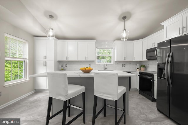 808 Pasadena Ave, Severna Park, MD 21146 - kitchen with black appliances, backsplash, vaulted ceiling, white cabinets, and a kitchen bar