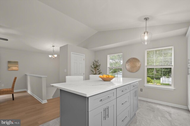 808 Pasadena Ave, Severna Park, MD 21146 - kitchen featuring pendant lighting, lofted ceiling, a center island, light stone countertops, and baseboards