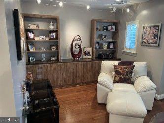 23294 Evening Primrose Sq, Brambleton, VA 20148 - living area featuring wood finished floors and a ceiling fan
