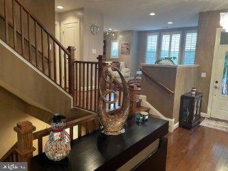 23294 Evening Primrose Sq, Brambleton, VA 20148 - staircase with wood finished floors, recessed lighting, and baseboards