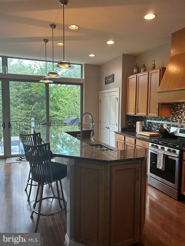 23294 Evening Primrose Sq, Brambleton, VA 20148 - kitchen featuring gas range, premium range hood, a sink, tasteful backsplash, and dark stone counters