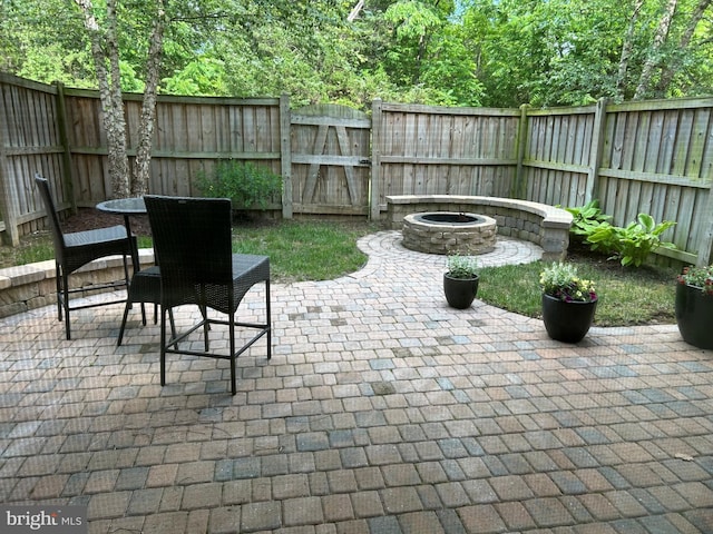 23294 Evening Primrose Sq, Brambleton, VA 20148 - fenced backyard with a patio, an outdoor fire pit, and a gate