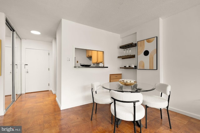 1301 20th St NW Unit 312, Washington, DC 20036 - dining area with baseboards and a textured ceiling