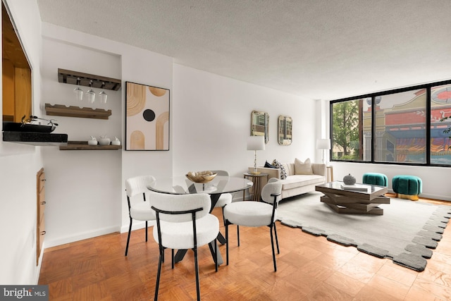 1301 20th St NW Unit 312, Washington, DC 20036 - dining area featuring a textured ceiling