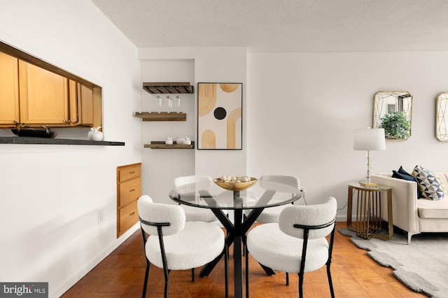 1301 20th St NW Unit 312, Washington, DC 20036 - dining room featuring a textured ceiling and baseboards