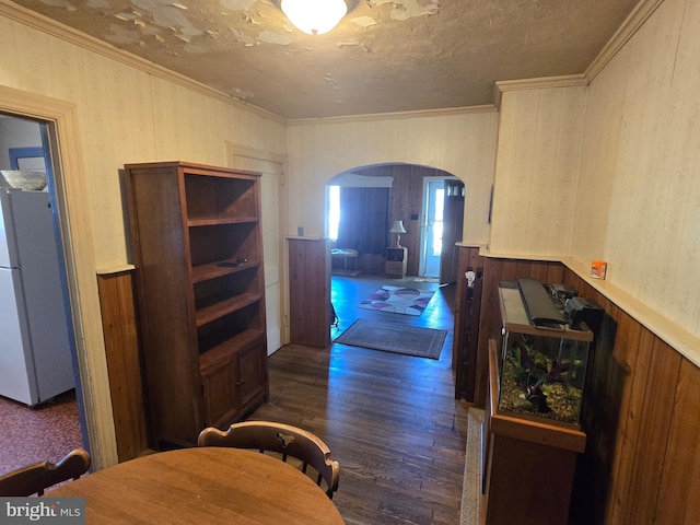 408 Dover St, Salisbury, MD 21804 - dining room featuring arched walkways, dark wood-style flooring, wood walls, crown molding, and a textured ceiling