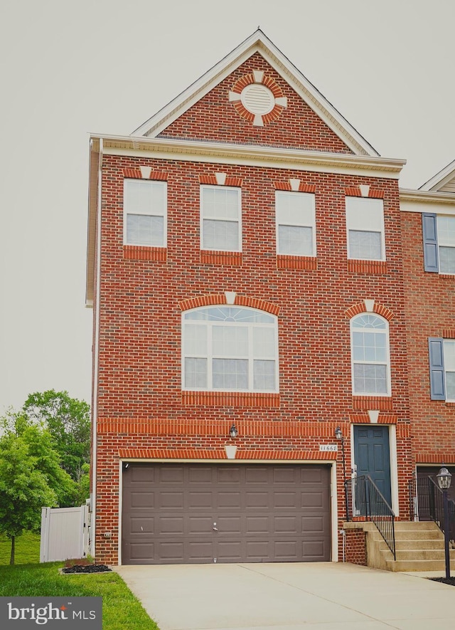11668 Palm Desert Pl, Waldorf, MD 20602 - view of front of house with an attached garage, brick siding, and concrete driveway