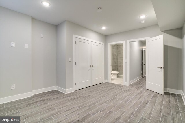 5005 Walnut St, Philadelphia, PA 19139 - unfurnished bedroom featuring baseboards, light wood-type flooring, ensuite bathroom, recessed lighting, and a closet