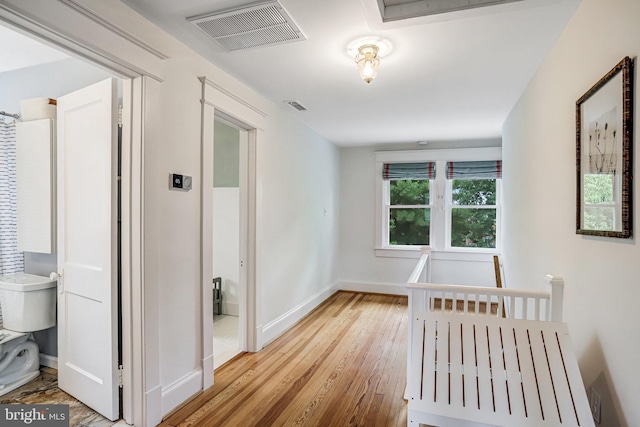 815 Aspen St NW, Washington, DC 20012 - hallway with wood finished floors, baseboards, and an upstairs landing
