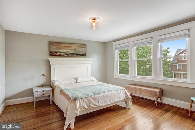 815 Aspen St NW, Washington, DC 20012 - bedroom featuring baseboards, wood-type flooring, and radiator heating unit