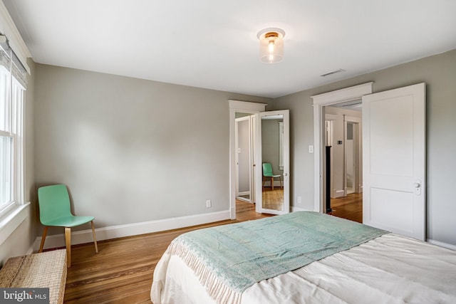 815 Aspen St NW, Washington, DC 20012 - bedroom featuring multiple windows, wood finished floors, and baseboards