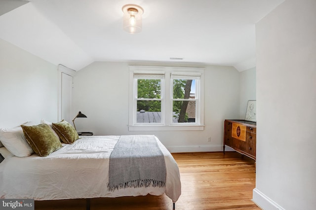 815 Aspen St NW, Washington, DC 20012 - bedroom with lofted ceiling, light wood finished floors, and baseboards