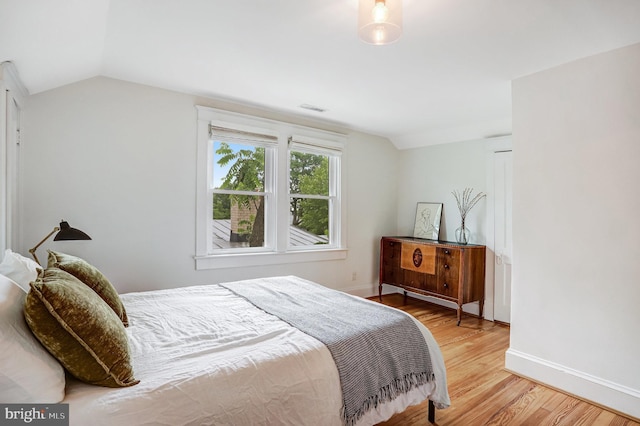 815 Aspen St NW, Washington, DC 20012 - bedroom featuring light wood-style flooring, lofted ceiling, and baseboards